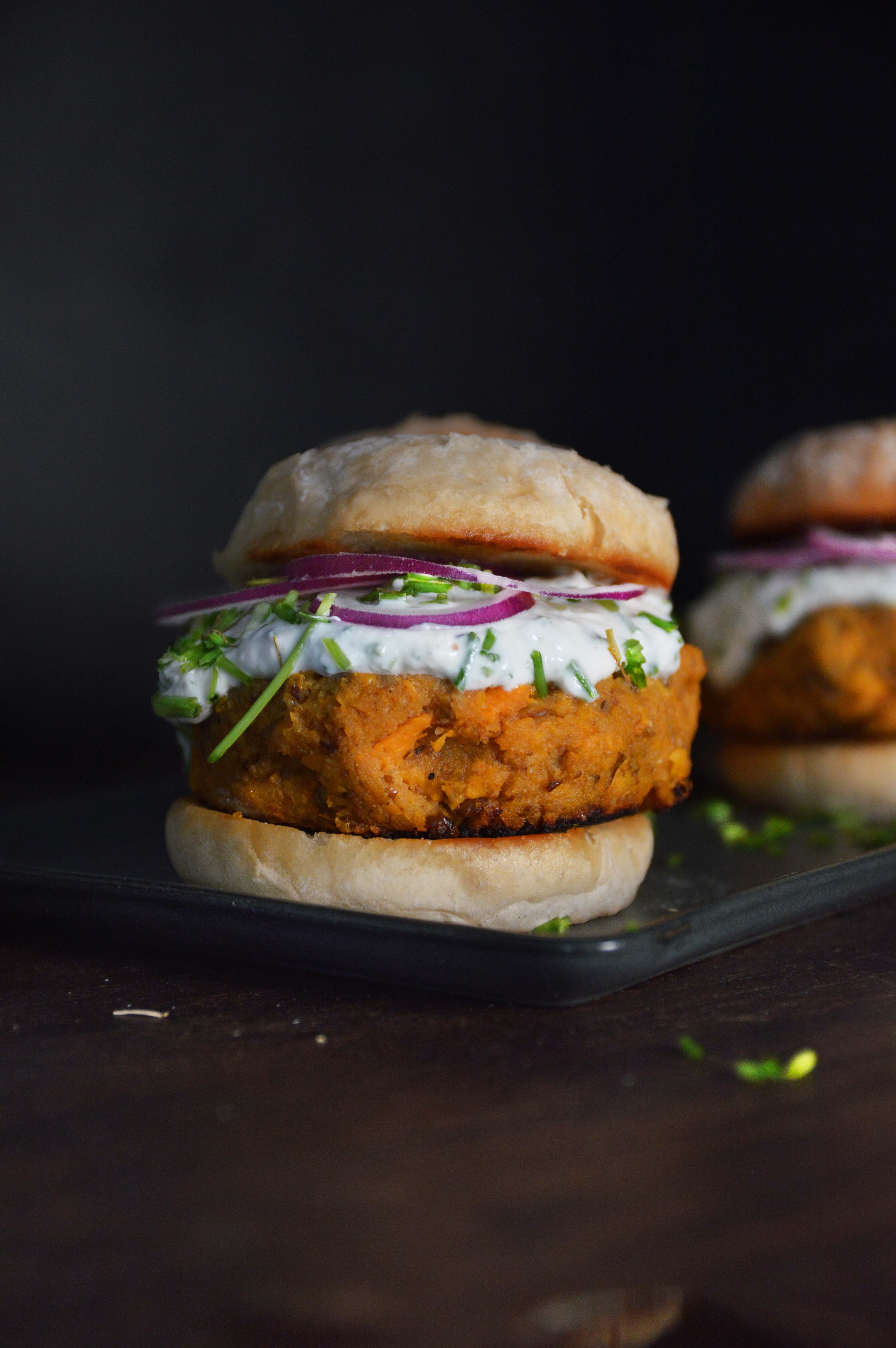 <orangeHeader>Sweet Potato Burger</orangeHeader> <br><br>
													This one looks harder to make, I mean it isn't cause ALL our recipes are ridiculously easy to make.
														But it feels like a Saturday night meal so thats how we label it
																<br><br>
																 Don't get me wrong I love a good standard burger, but lets get a little experiemental. I mean we are here to try some new things,
																 its a Saturday night and we want to cook something nice and fun. Try this delicious plant burger and impress your date
															 <br><br>
															 <b>Full recipe available in the app but here is breakdown of what this is:</b>
															 <br><br>
															 <b>1.</b> The burger is based on sweet potatos, lentils, eggs and breadcrumbs. Mix it all and fry on high heat til golden
															 <br>
															 <b>2.</b> Sauce made with mayo, greek yoghurt and shredded horseradish
															 <br>
															 <b>3.</b> Fry some bread and top everything with red onions and fresh chives